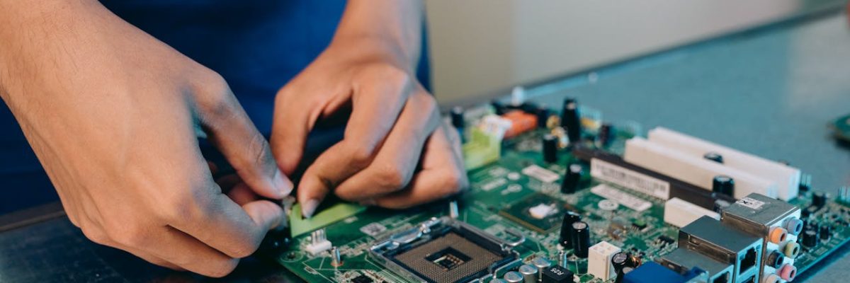 Hands-on assembly of a computer motherboard with precision tools.